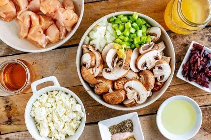 Overhead photo of recipe ingredients in prep containers - Chopped raw chicken, mushrooms, celery, onion, olives, seasonings, oil, and cooking sherry.