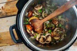 Mushrooms, celery and onion cooking in a pressure cooker.