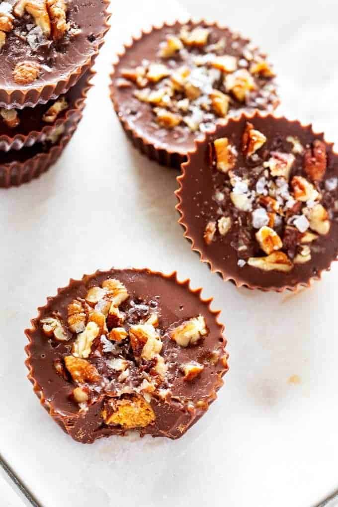 Photo of six Keto Chocolate Peanut Butter Cups on a white background.