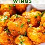 Close up photo of Keto Cauliflower wings garnished with parsley with the recipe title about the wings.