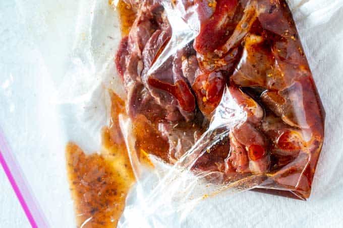 Photo of cubed lamb in a zip top bag with marinade.