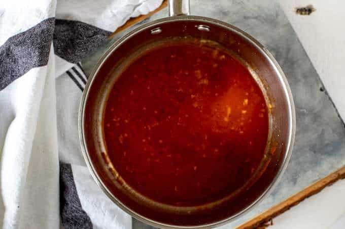 Photo of buffalo sauce and butter in a medium sauce pan.