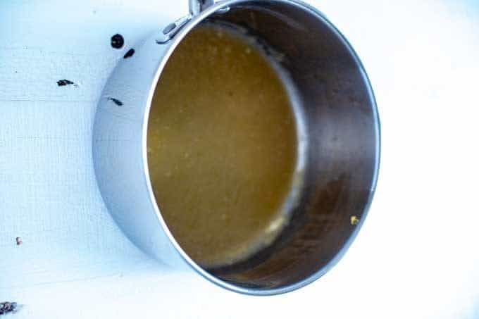 Photo of lemon juice, lemon zest, xanthan gum, and serve cooking in a sauce pan.