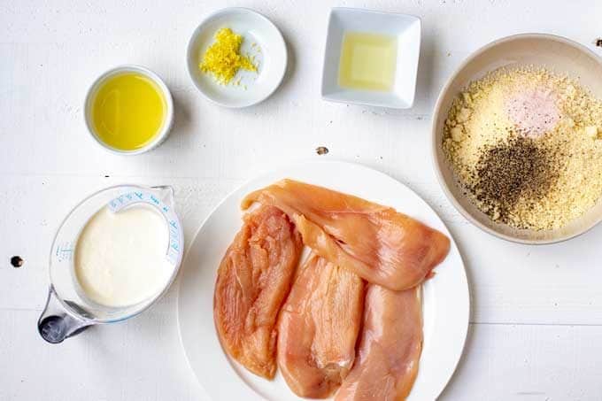 Photo of pounded chicken breast, almond flour, Parmesan, seasonings, lemon juice, lemon zest, oil, and heavy cream.