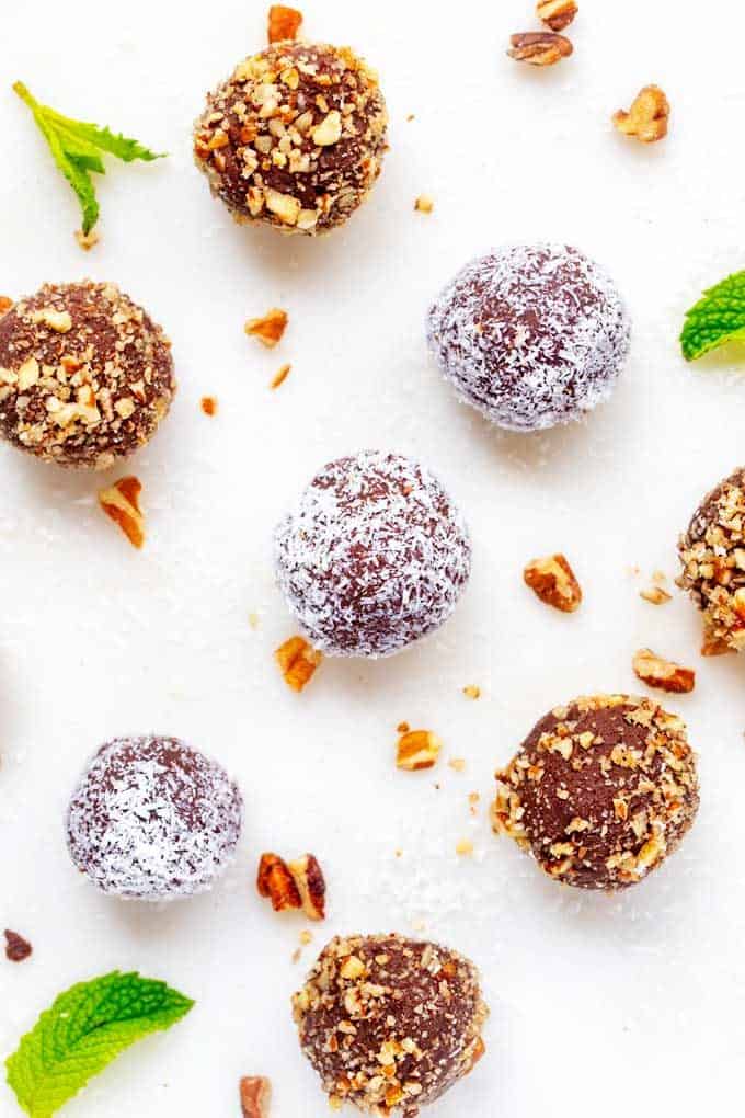 Photo of Keto Chocolate Truffles lined up on a white marble cutting board.
