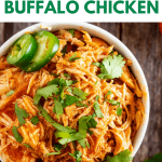 Overhead photo of a bowl of shredded buffalo chicken garnished with cilantro and jalapeno and the text Keto Slow Cooker Buffalo Chicken above.