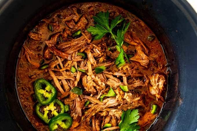 Overhead photo of Low Carb Slow Cooker Beef in a Crockpot garnished with cilantro and jalapeno.