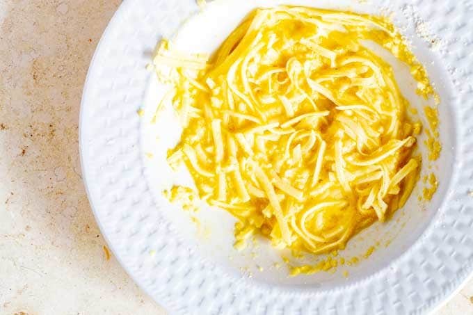 Photo of egg, cheese, and almond flour stirred together in a white bowl.