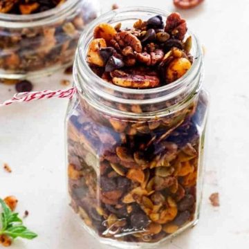 Side photo of a glass jar with keto trail mix in it.