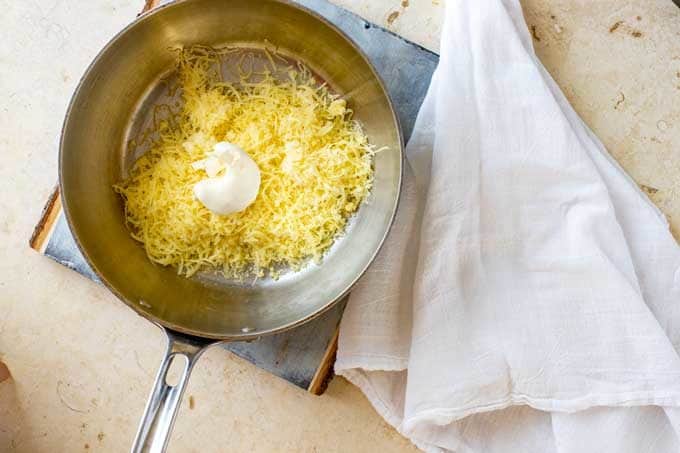 Photo of cream cheese and shredded mozzarella in a pot.