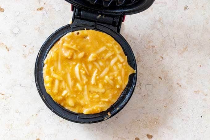 Photo of a keto chaffle in a dash mini waffle maker.