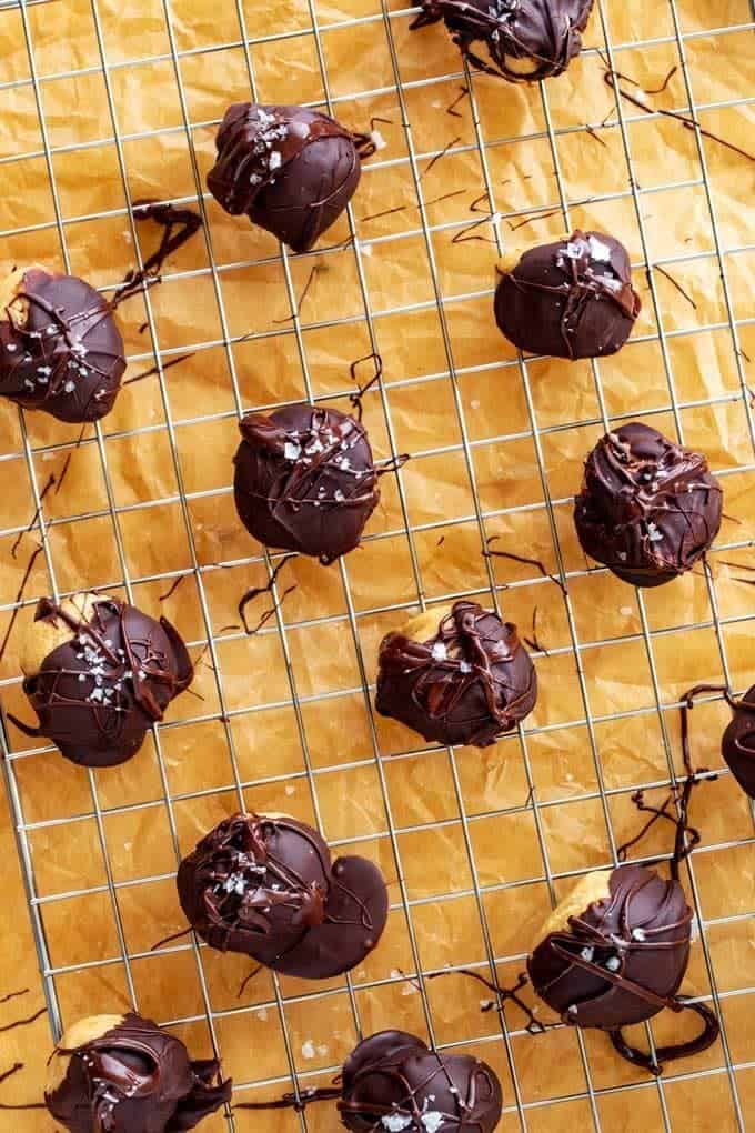 Overhead photo of no bake peanut butter balls on a wire cooling wrack on top of parchment paper.