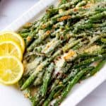 Photo of Roasted Green Beans with Parmesan on a white serving platter.