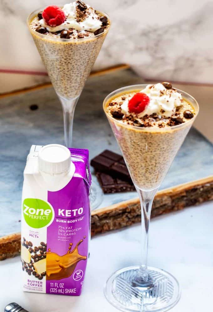 Photo of coffee chia pudding in tall glasses with a ZonePerfect Keto sitting next to it.