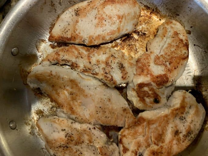 A skillet of chicken that has been browned.