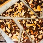 Close up square photo of Keto Chocolate Bark on a rustic cutting board.