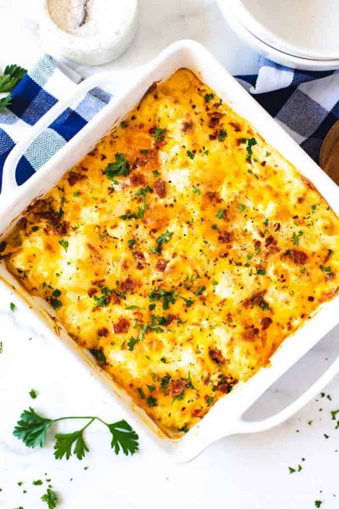 Overhead photo of a white casserole dish with keto cauliflower mac and cheese in it.