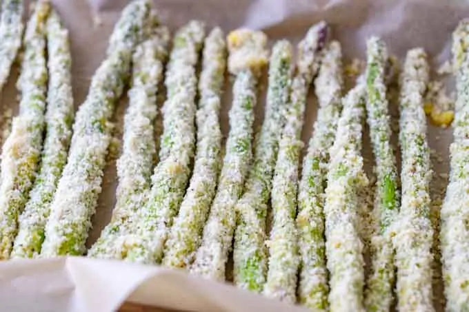 Photo of asparagus coated in parmesan and almond flour.