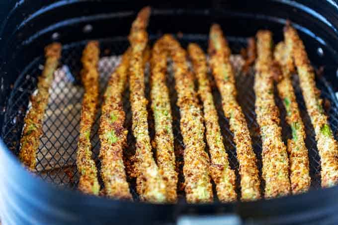 Photo of asparagus fries in an air fryer.