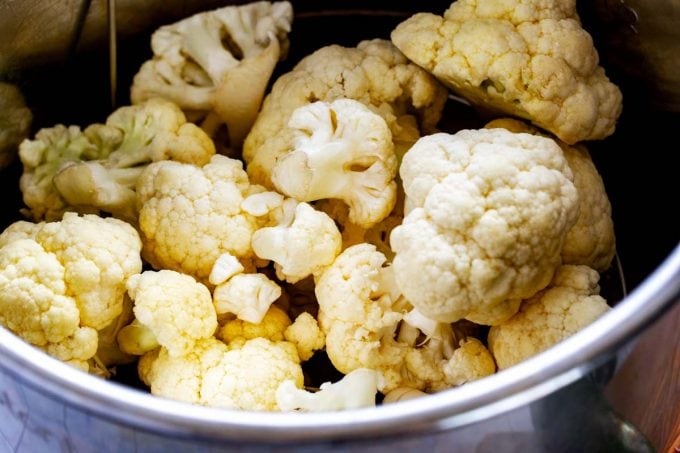 Photo of an Instant Pot with raw cauliflower in it.