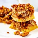 Square side photo of keto pecan bars against a white background.