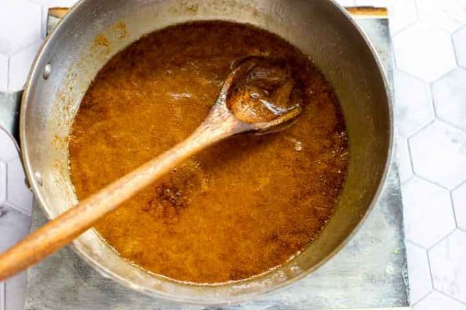 Photo of a saucepan with a mixture of keto brown sugar and maple syrup in it.