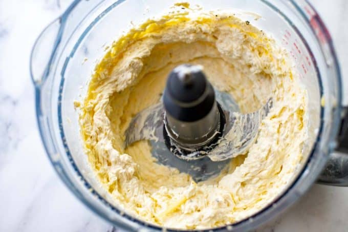 Photo of cheese and cream cheese in a food processor after being blended.