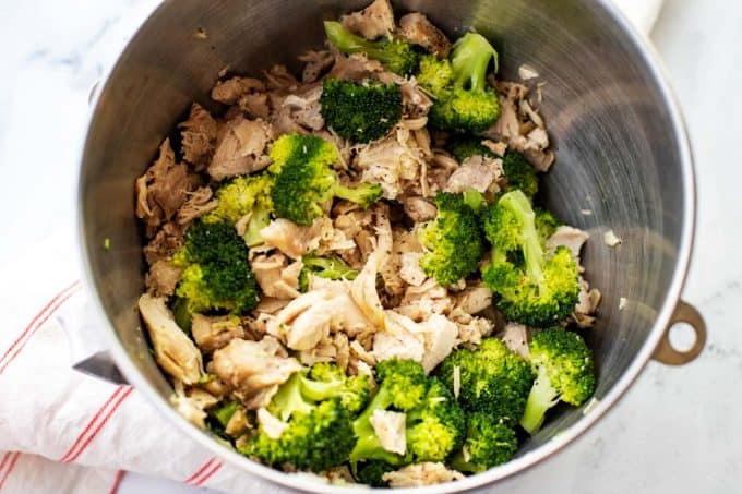 Photo of chicken and steamed broccoli in a large bowl.