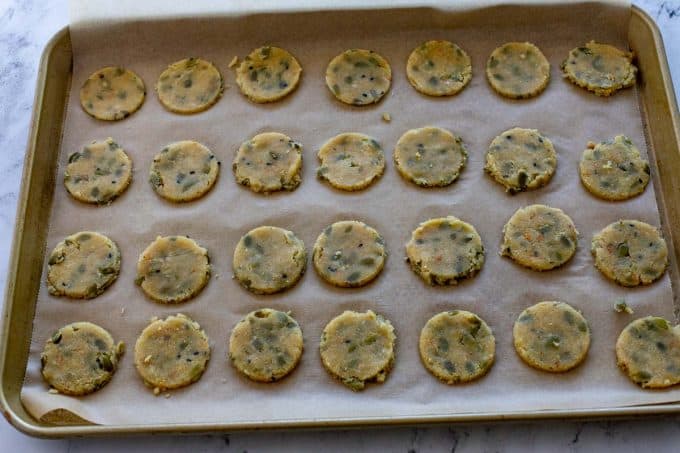 Photo of a sheet pan with uncooked crackers on it.