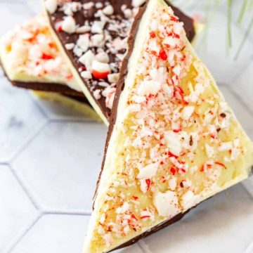 Close up photo of white and dark peppermint bark on a white background.