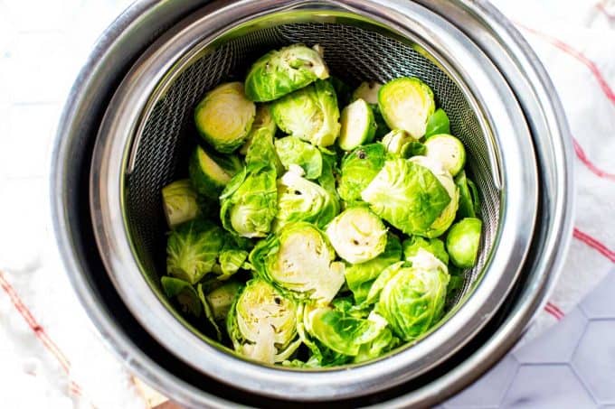 Photo of Brussels Sprouts in a steamer basket in an Instant Pot.
