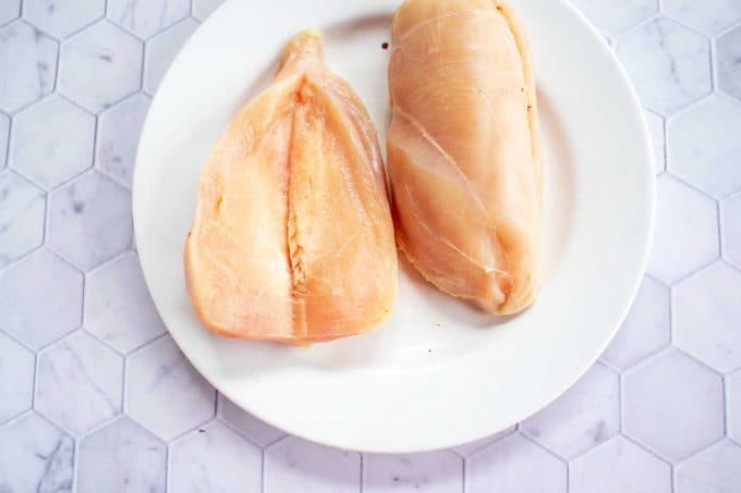 Photo of chicken on a white plate with a horizontal slit through it.