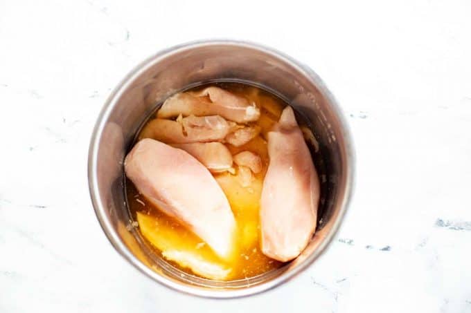 Photo of chicken and chicken broth in an Instant Pot.