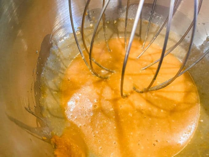 Eggs, pumpkin puree, butter, heavy cream, and vanilla beaten together in the bowl of a stand mixer.