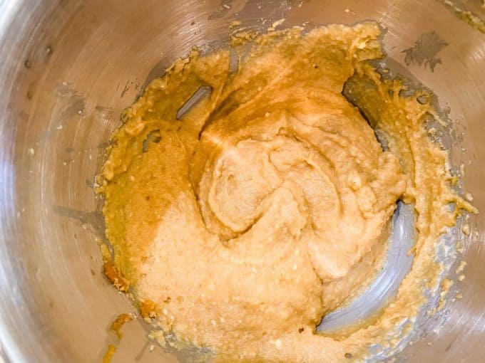Batter for keto pumpkin muffins in the bowl of a stand mixer.