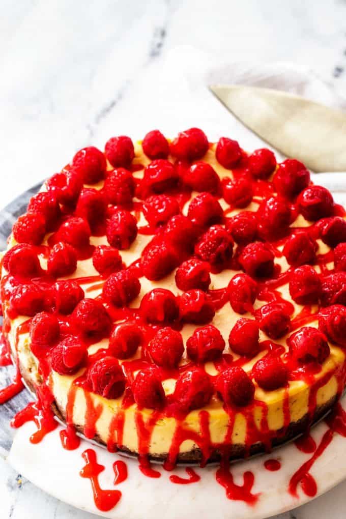 Side photo of a keto cheesecake with raspberries.