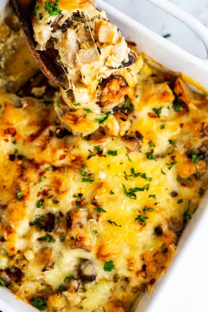 Close up photo of a keto turkey casserole with a cheesy spoon being pulled from it.