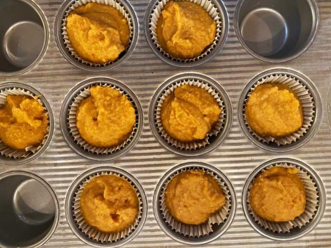 Muffin tin with keto pumpkin muffins ready to be baked.