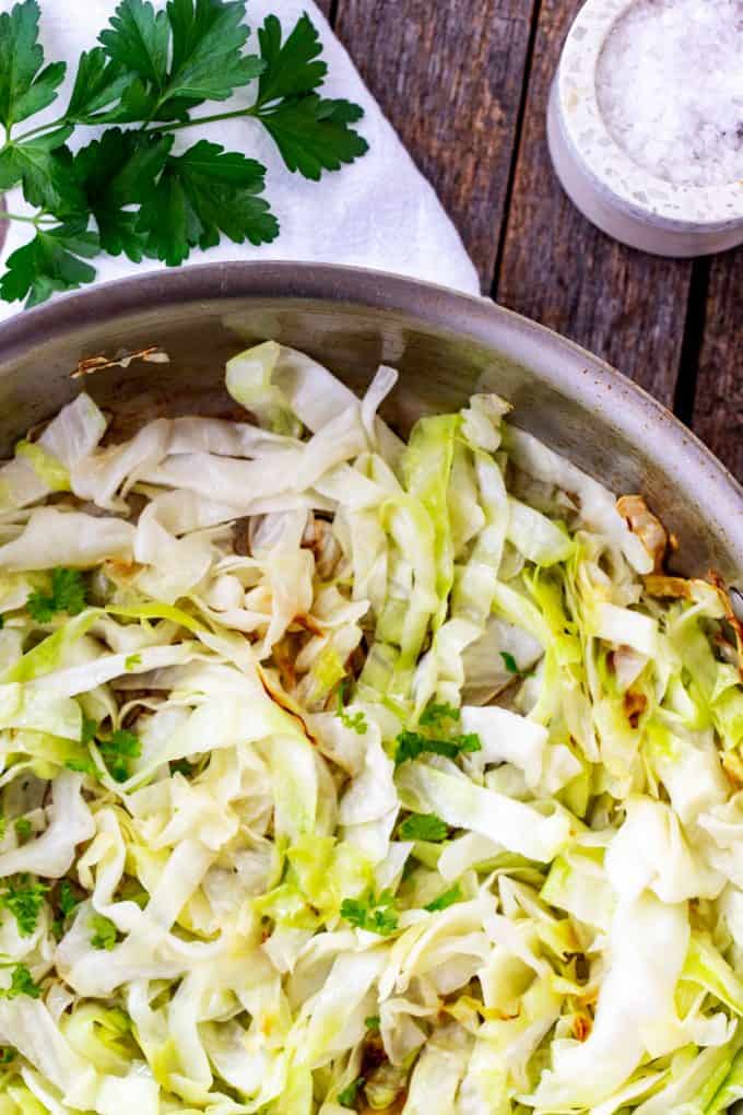 Photo of a skillet of cooked cabbage noodles.
