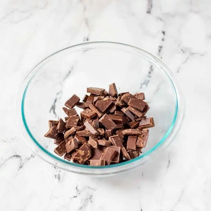Photo of cut chocolate in a glass bowl.