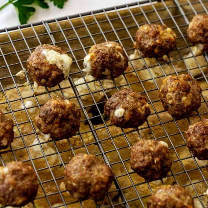 Square photo of cooked cheesy keto stuffed meatballs.
