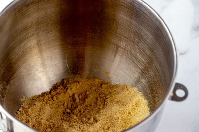 Bowl of a stand mixer with almond flour, oat fiber, baking powder, xanthan gum, and salt.