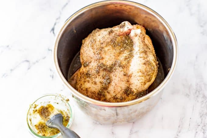 Instant Pot with a frozen whole chicken in it.