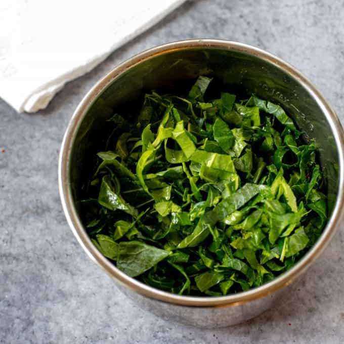 Collard greens that have been added to an instant Pot.