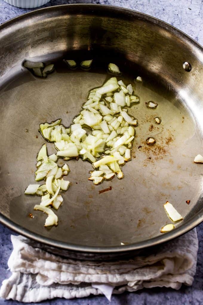 Photo of Onion in a skillet cooking.