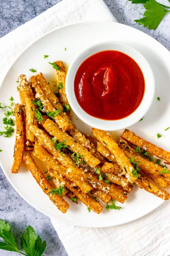 Overhead photo of a plate of Keto Jicama Fries with a small dish of ketchup.