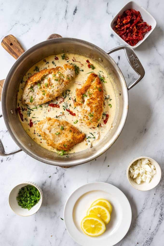 Photo of a skillet where chicken has been added to a cream sauce.