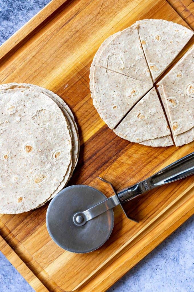 Photo of a cutting board with low carb tortillas being cut.