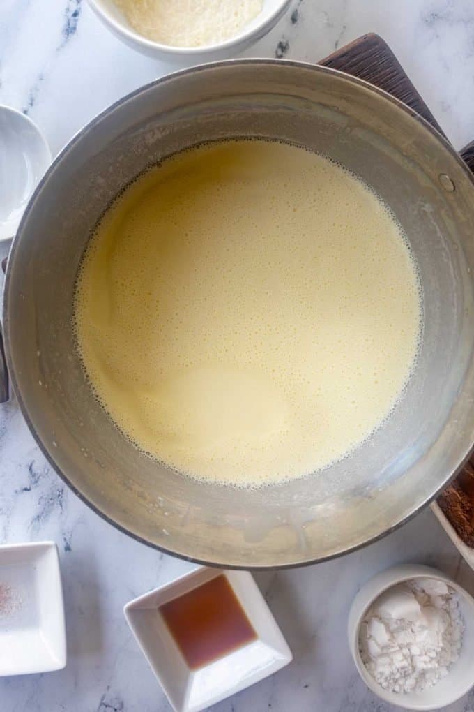 Overhead photo of a sauce pan with heavy cream.