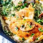 Close up square photo of Keto Creamy Chicken in a cast iron skillet.